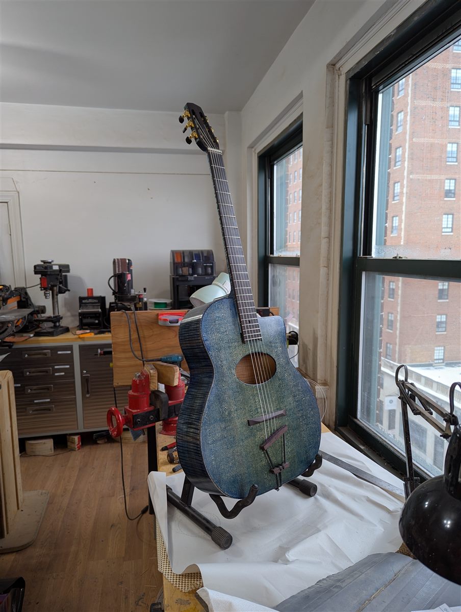 Front view of the Blue Selmer guitar showing the teal-blue mottled finish and floating bridge.