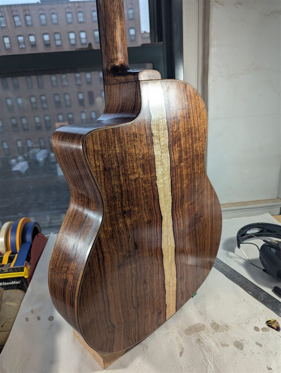 Side and back detail of the granadillo back and sides, showing dense figured grain.