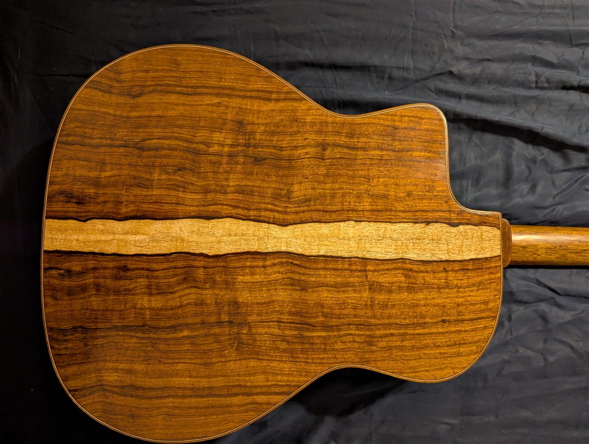 Full back of the Granadillo guitar showing the bookmatched grain and center stripe.