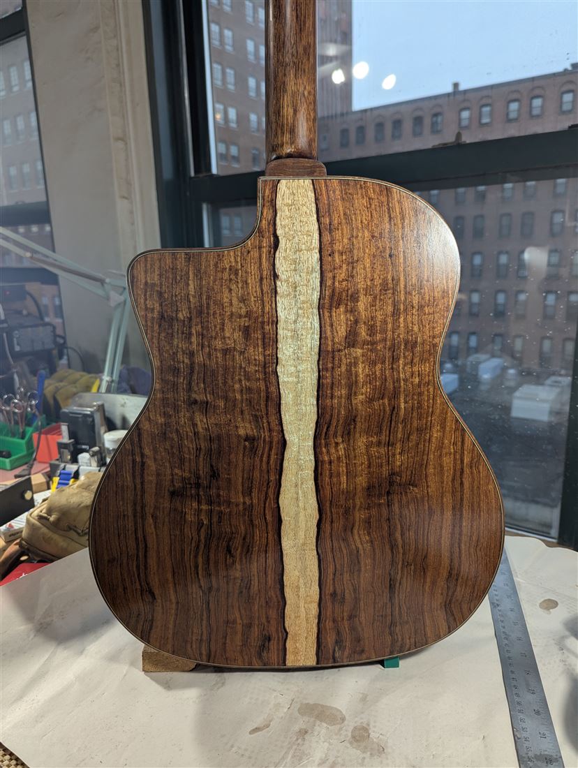Full back view of the Granadillo guitar showing dark, richly figured wood.