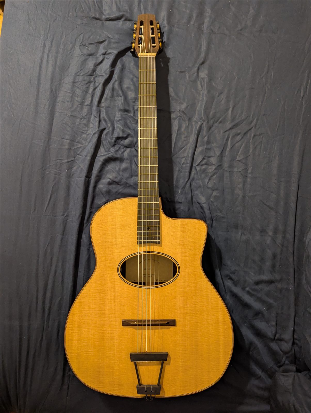 Handbuilt gypsy jazz guitar with natural spruce top by Paul McEvoy Guitars.