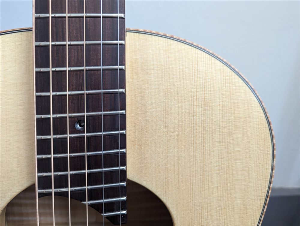 Headstock and neck heel detail of the Maple Steel guitar.