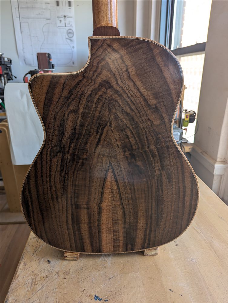 Bookmatched walnut back panel with dramatic dark grain striping on a handbuilt Paul McEvoy guitar.