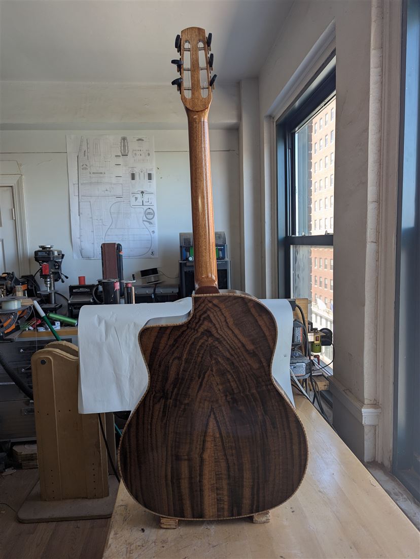 Interior shop label reading Paul McEvoy Guitars No. 24, Portland, Maine, Redwood/Walnut, visible through the soundhole.