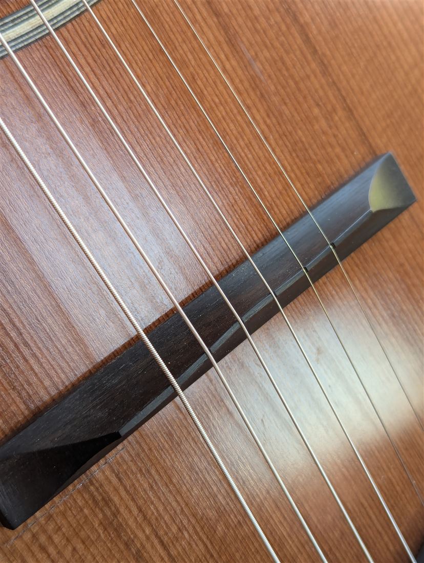 Three-quarter view of the New Walnut guitar's body and neck.
