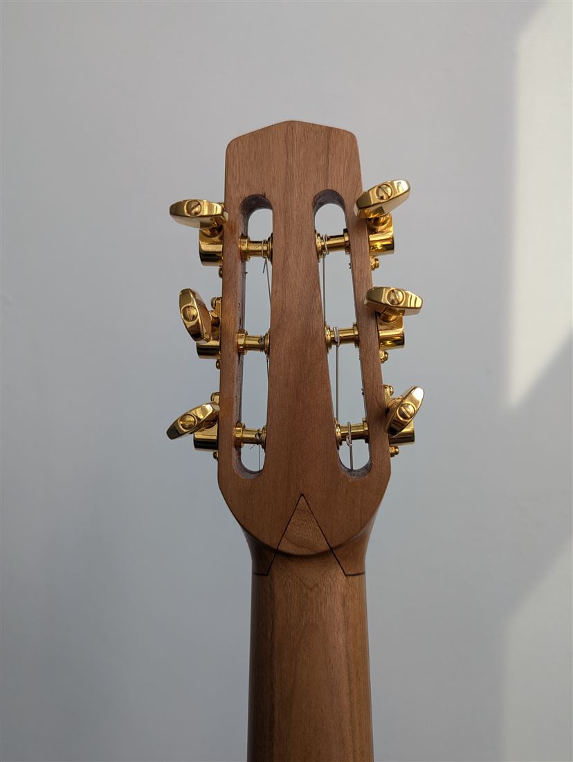 Rear headstock detail of the Old Walnut guitar.