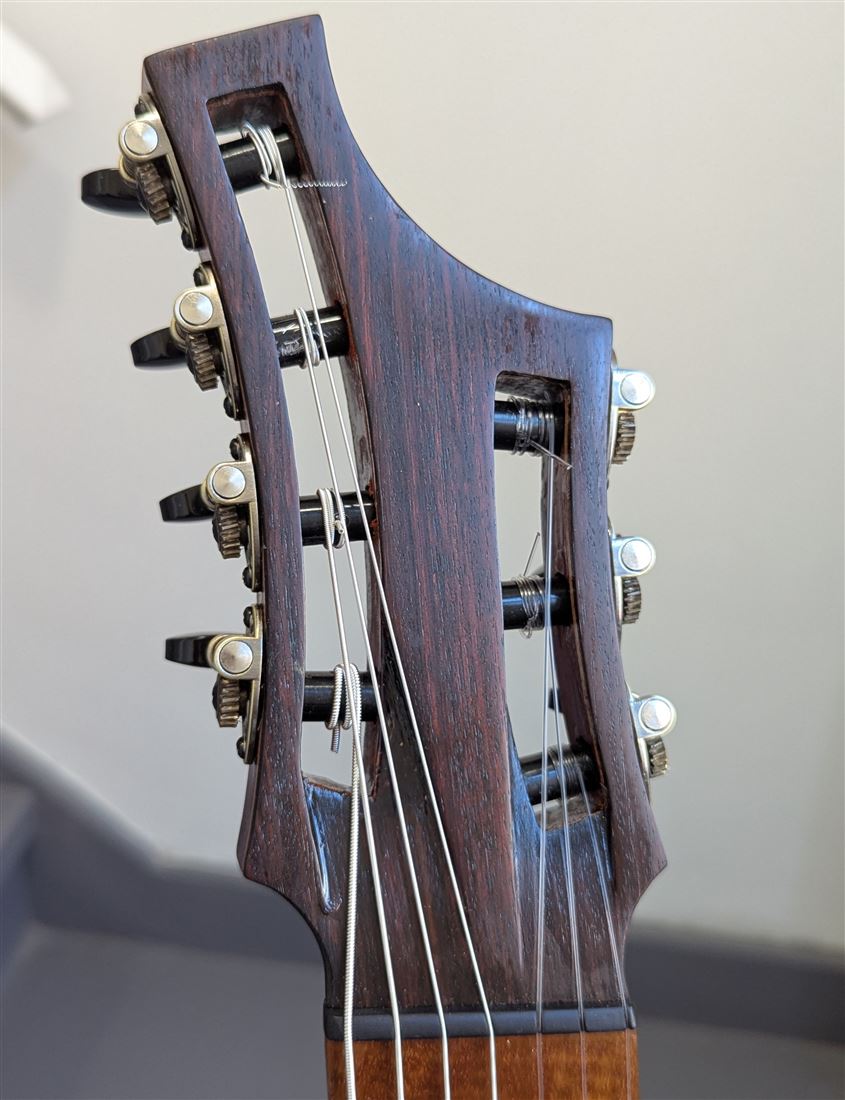 Close-up of the headstock and neck of the 7-string multiscale guitar.