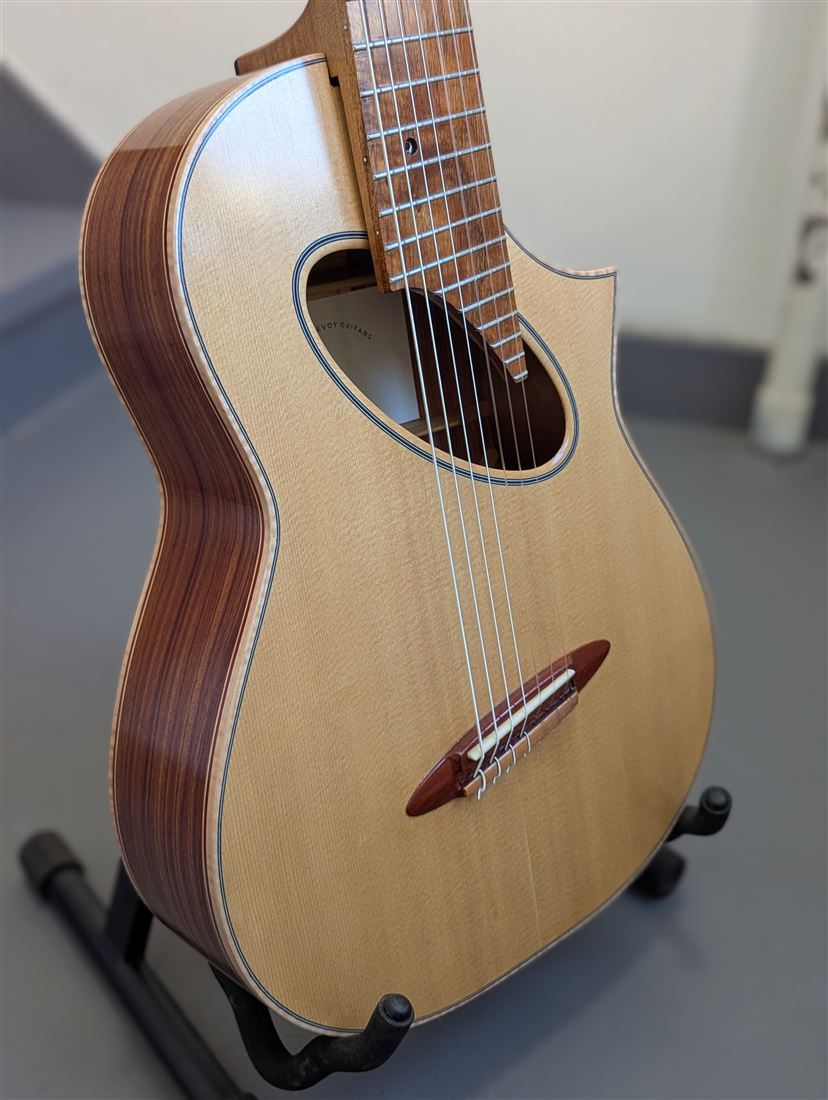 Three-quarter detail view of the 7-string guitar showing the neck joint and back wood.