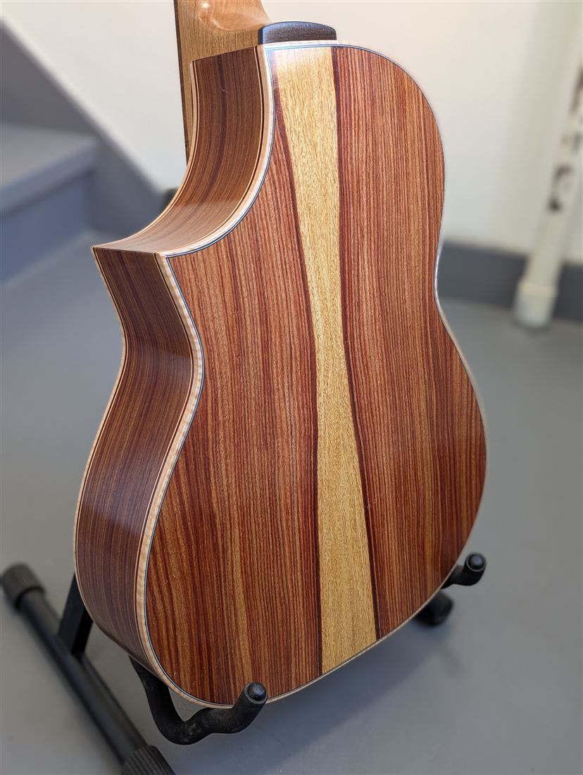 Back of the 7-string guitar showing bookmatched wood grain with a light center stripe.