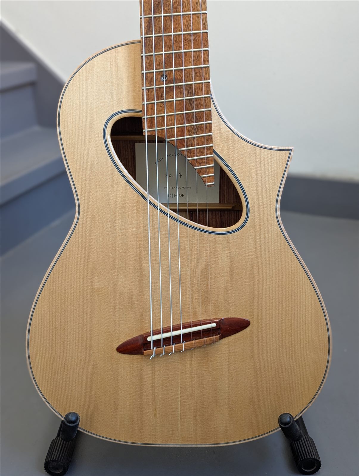 Handbuilt 7-string multiscale nylon-string guitar with oval soundhole by Paul McEvoy Guitars.