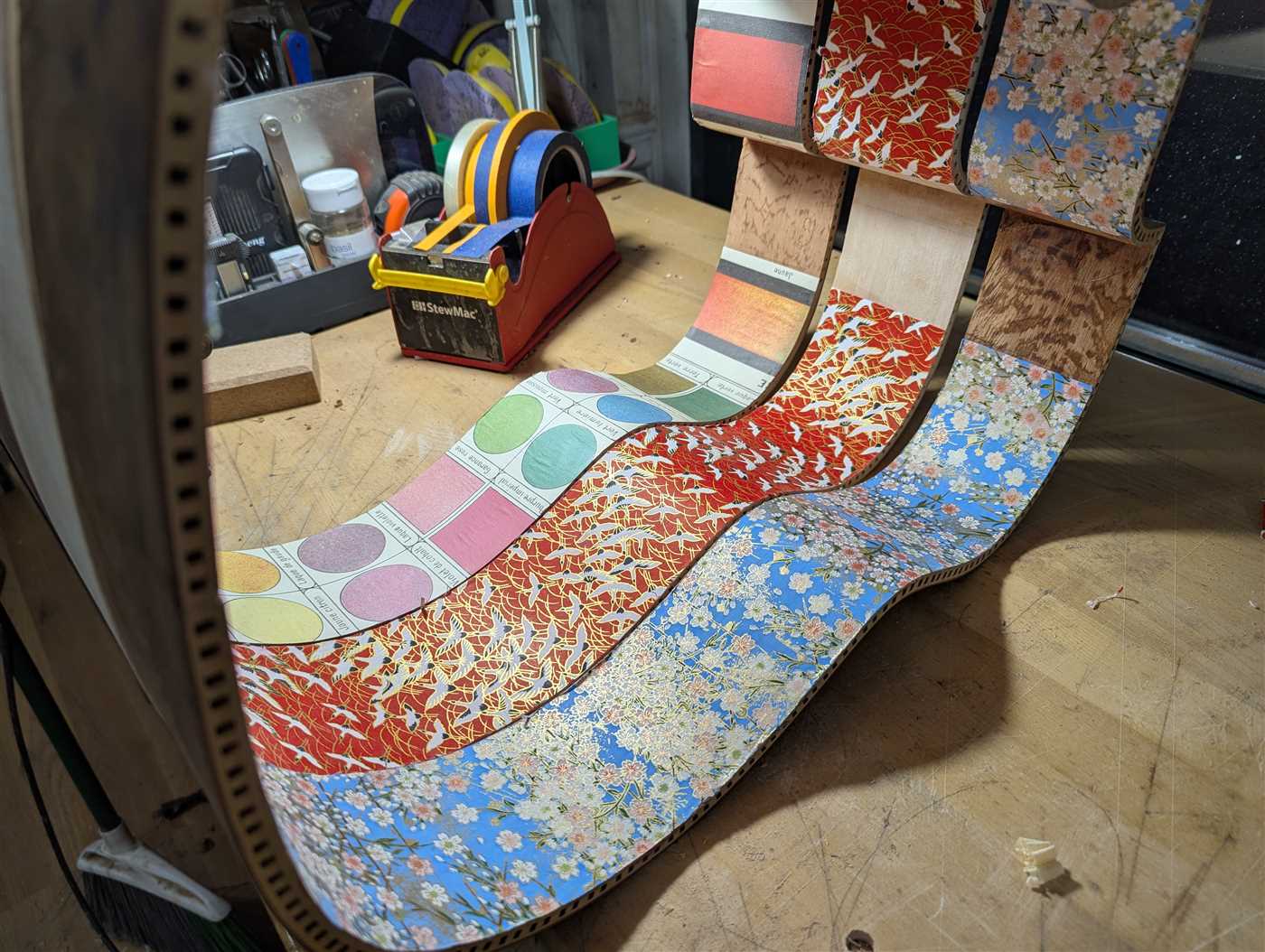 Three sets of guitar sides with artist's paper applied.