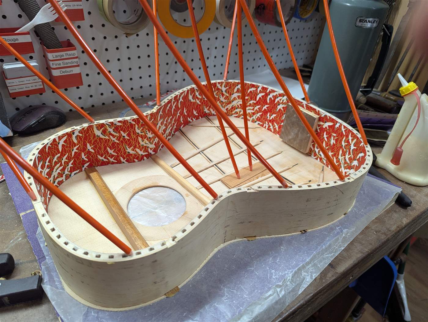Gluing the top on a flamenco guitar.