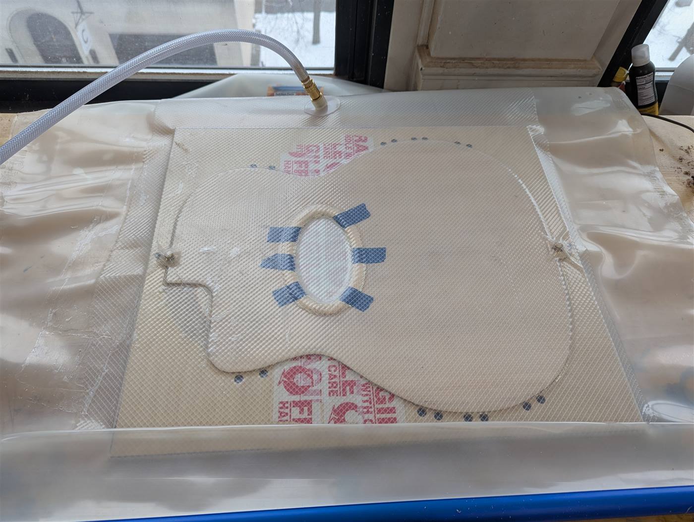 Vacuum gluing a soundhole reinforcement ring.