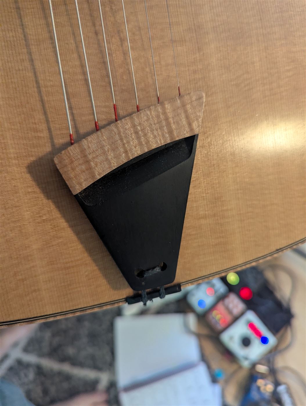 A floating violin style tailpiece for a Selmer style guitar.